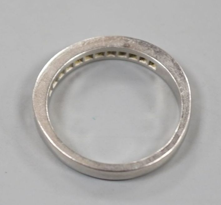 A platinum and twelve stone diamond set half eternity ring, size R, gross weight 6.4 grams.